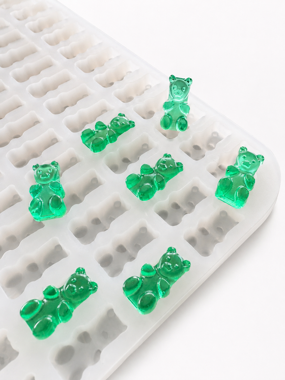 Angled close-up of the 1.5mL 296-cavity gummy bear mold with translucent emerald green gummies